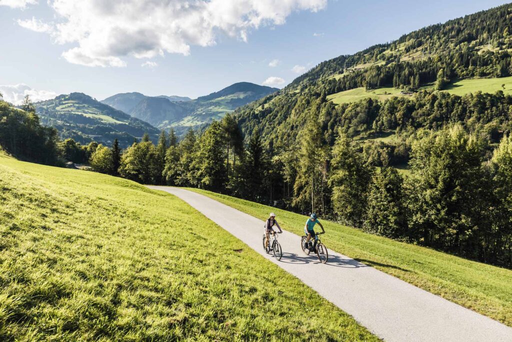 2 Radfahrer auf dem Tauernradweg durchqueren gerade Altenmarkt im Pongau